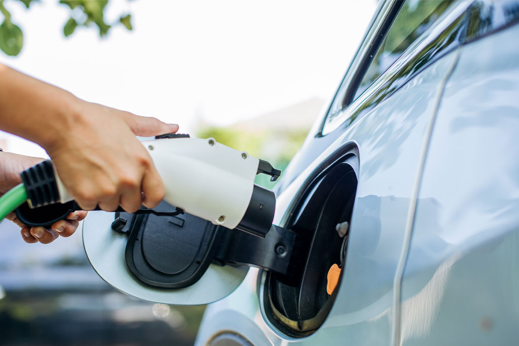 Person plugging in electric car